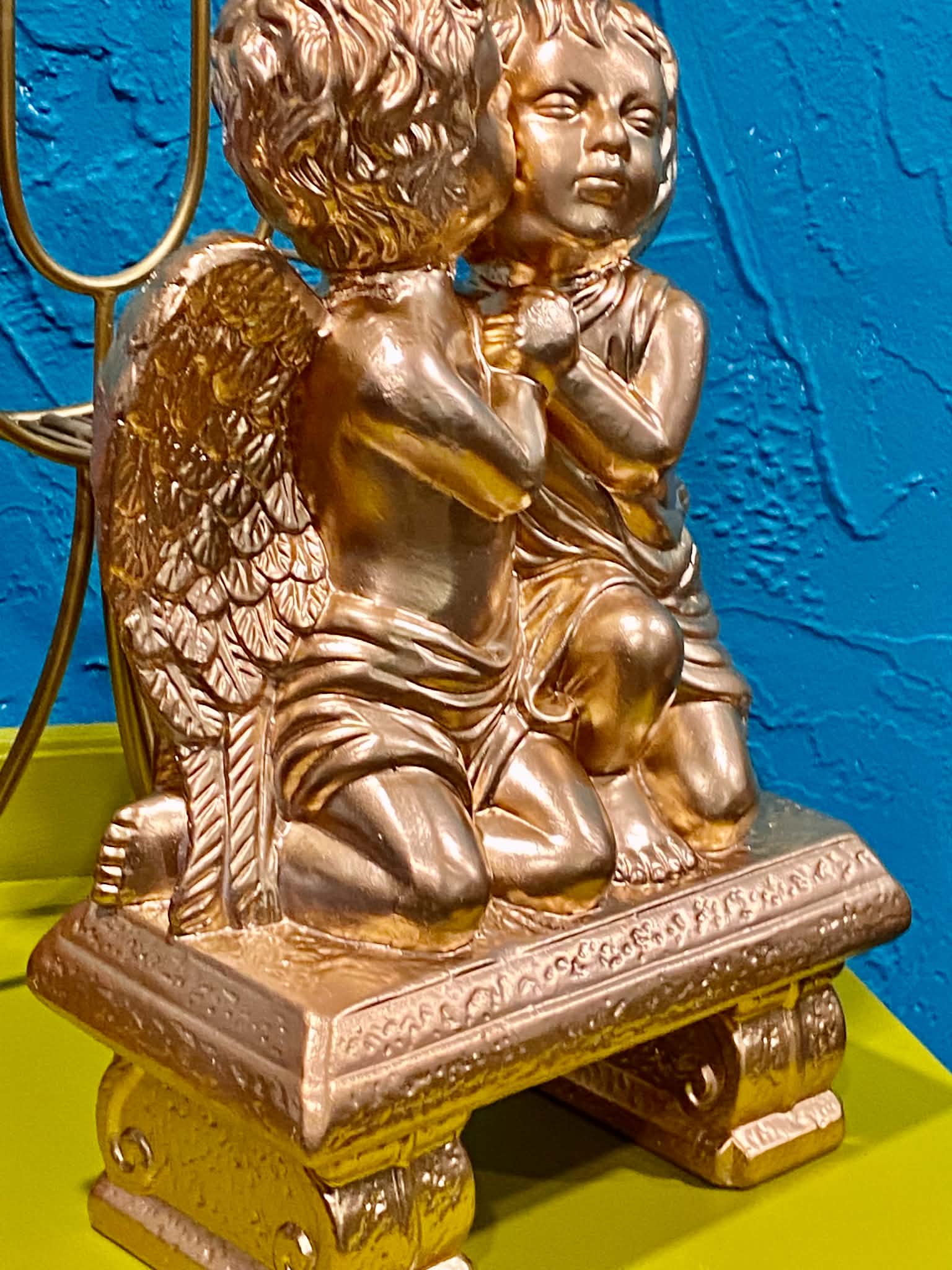 Gold cherubic figurine with wings